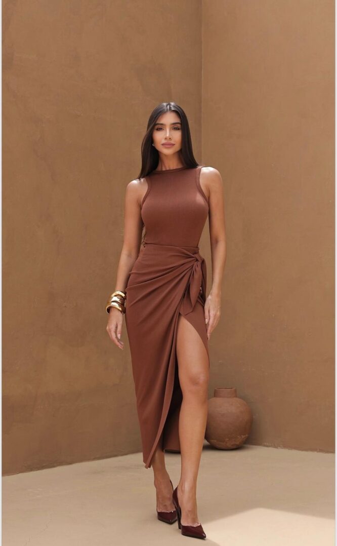 Woman in brown dress with slit.