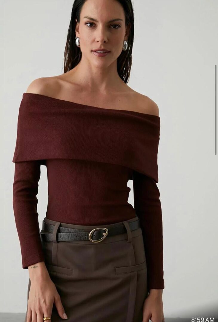 Woman in off-shoulder top and skirt.