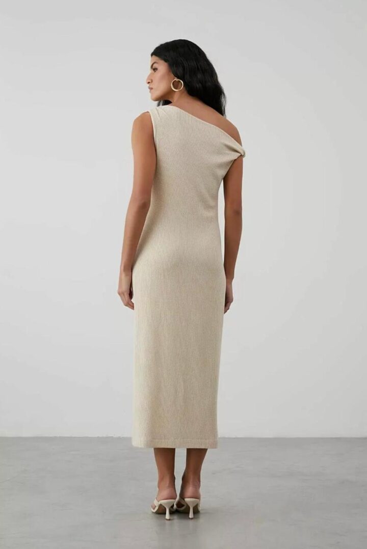 Woman in beige one-shoulder dress, back view.