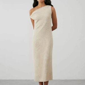 Woman in beige one-shoulder dress standing.